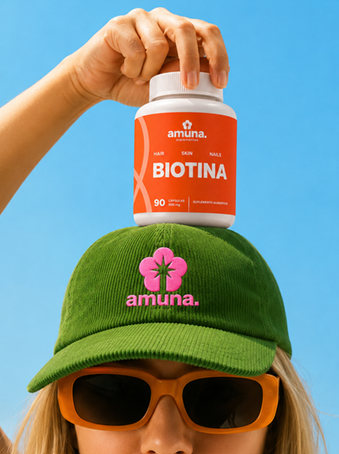 Modelo sosteniendo un frasco de Biotina Amuna, usando la gorra oficial de la marca